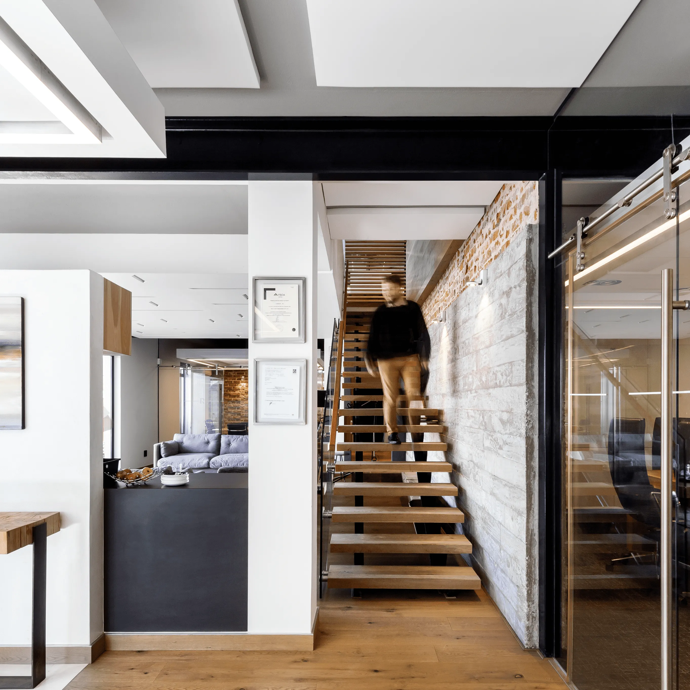 A man walking down an office staircase